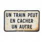 "Un train peut en cacher un autre" sign prop by KOZIEL